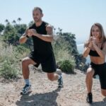 Compound Exercises - A Man and Woman Working Out Near the Cliff