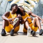 Exercise - 2 women in yellow tank top and black shorts sitting on white bench during daytime