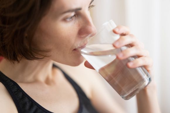 Drink Water - woman in black tank top drinking water