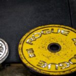 Effective Workouts - a pair of yellow and black weights sitting next to each other
