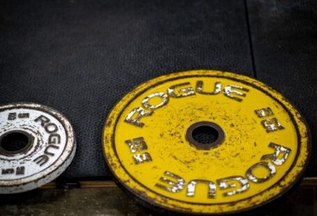 Effective Workouts - a pair of yellow and black weights sitting next to each other