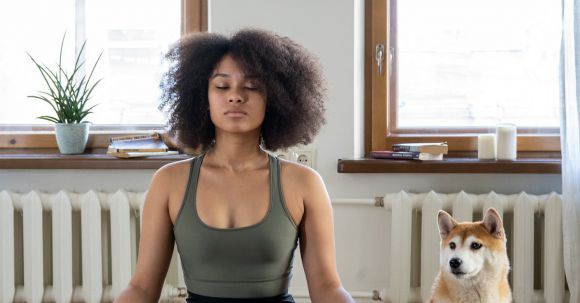 Home Workouts - Woman Meditating Beside her Dog