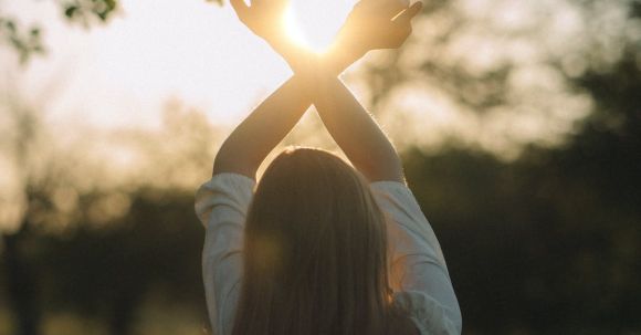 Stretching Integration - Young Woman Standing on the Meadow Stretching Her Arms Towards Rising Sun