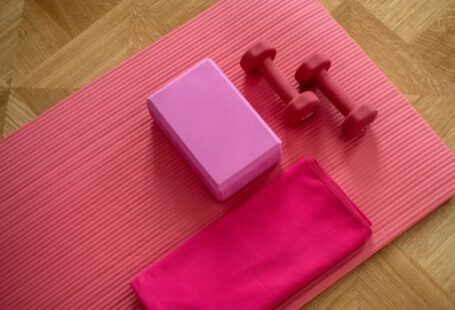 Exercise - pink dumbbell on pink textile