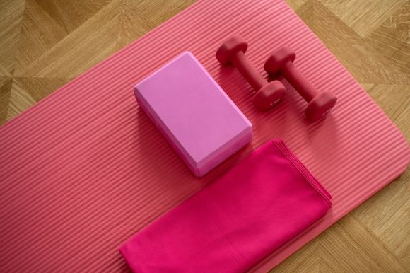 Exercise - pink dumbbell on pink textile