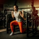 Ball Exercise - woman wearing gray shirt and orange leggings