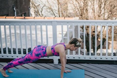 Core Strength - Slim female doing plank exercise during training outside