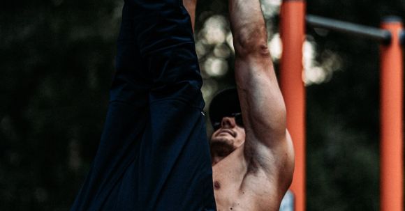 Toned Exercises - Toned Man Training on Bar Outdoors