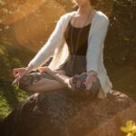 Personalized Fitness. - Woman Meditating on Rock