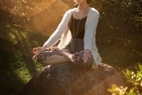 Personalized Fitness. - Woman Meditating on Rock