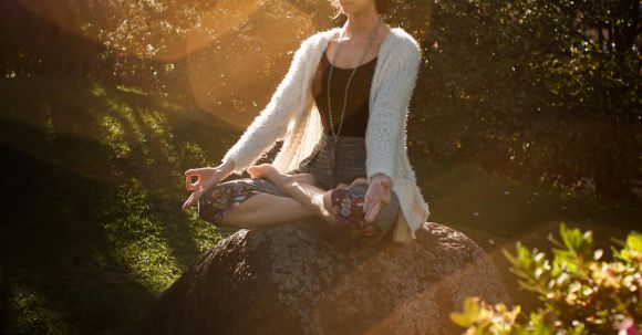 Personalized Fitness. - Woman Meditating on Rock
